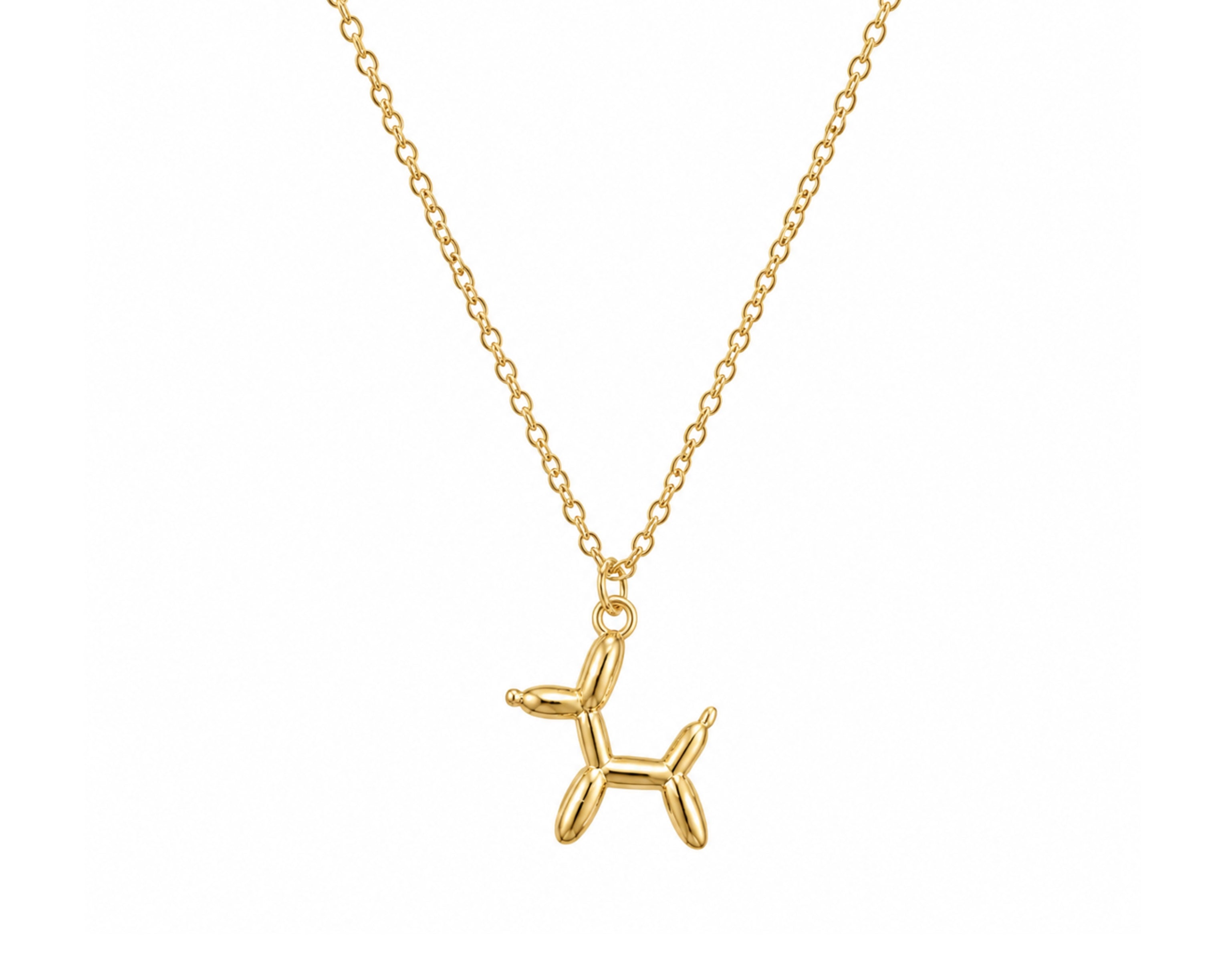 Gold Balloon Dog Pendant Necklace by SALVE featuring a shiny, sculpted balloon dog charm on a delicate chain.