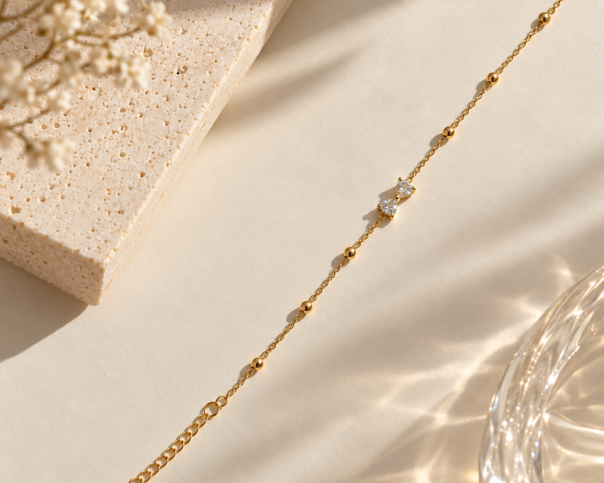 Gold-toned SALVE bow bracelet featuring a delicate bow charm and adjustable chain, stylish accessory for women.