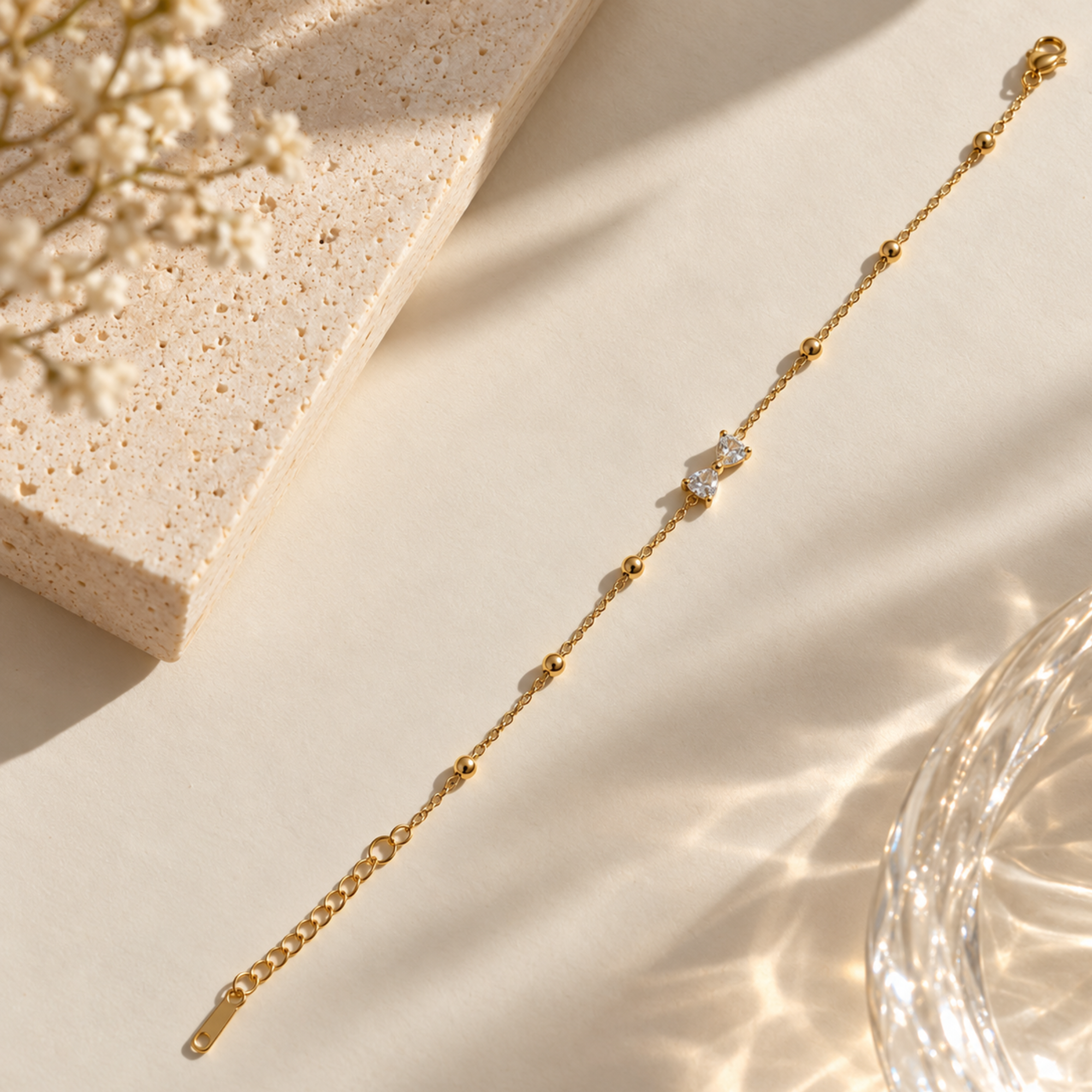Gold-toned SALVE bow bracelet featuring a delicate bow charm and adjustable chain, stylish accessory for women.