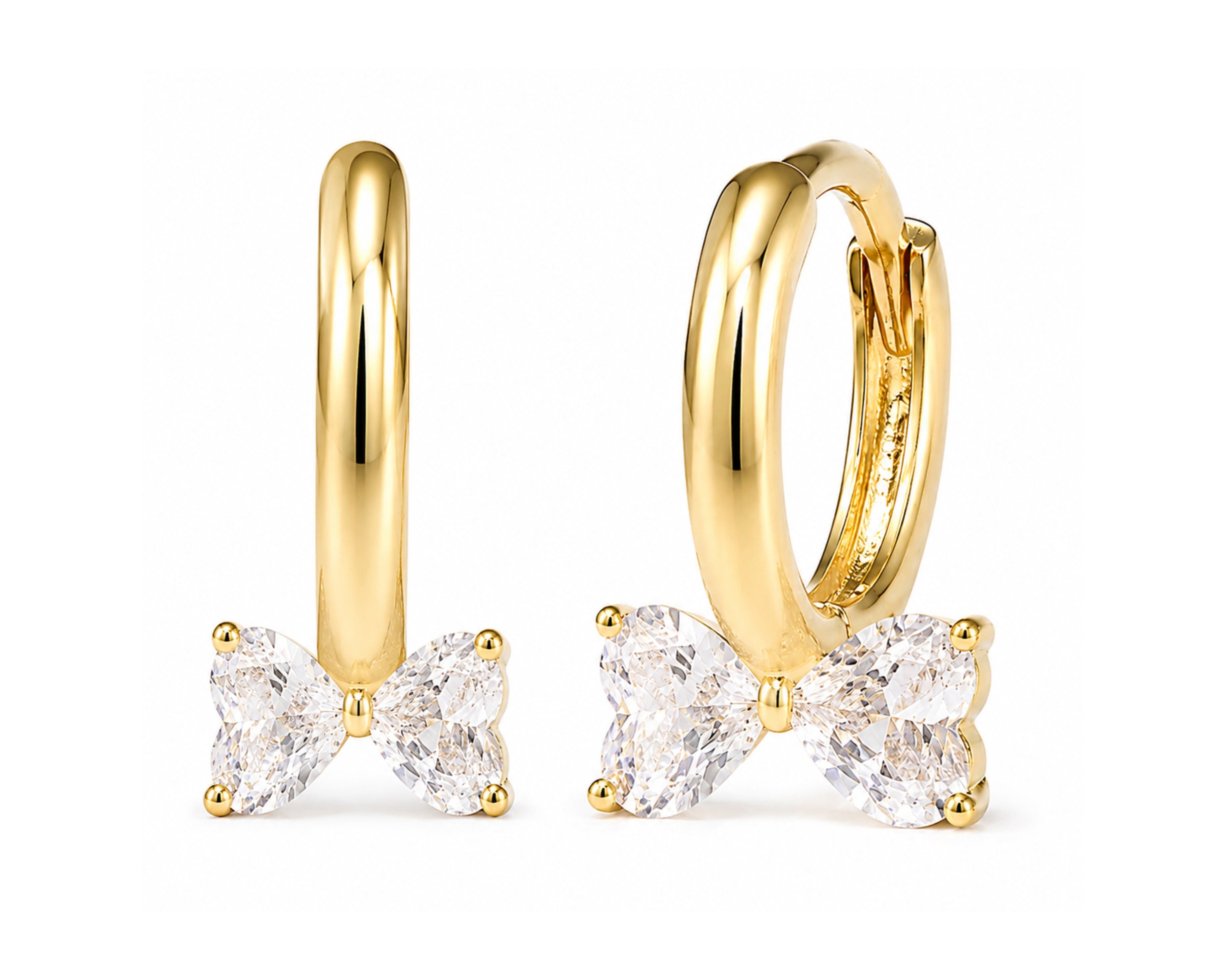 Gold tone SALVE hoop earrings with bow and heart design, featuring elegant gold-tone metal and a classic hoop style.