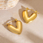 SALVE hinged hoop heart earrings with a sleek, polished design featuring a heart-shaped detail on silver hoops.