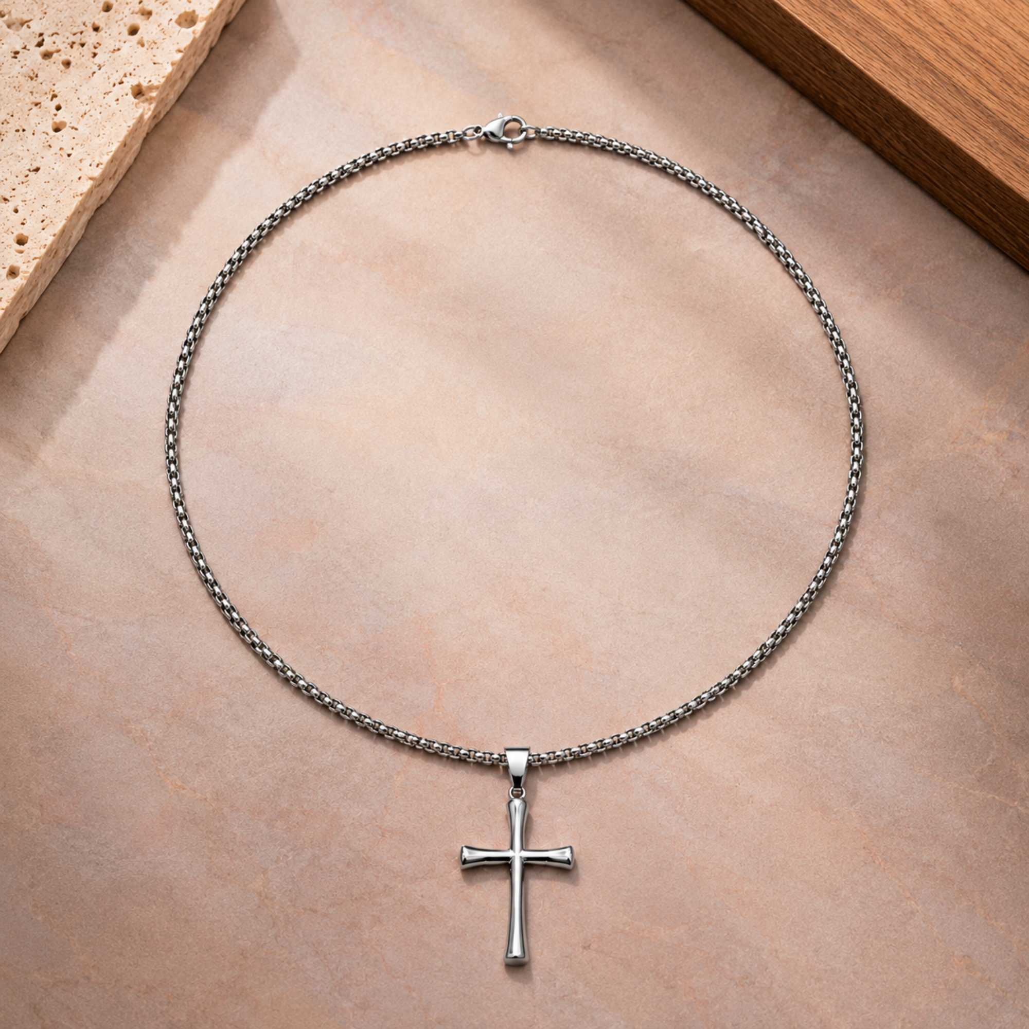 Silver-toned SALVE cross pendant necklace featuring a detailed cross design on a chain.