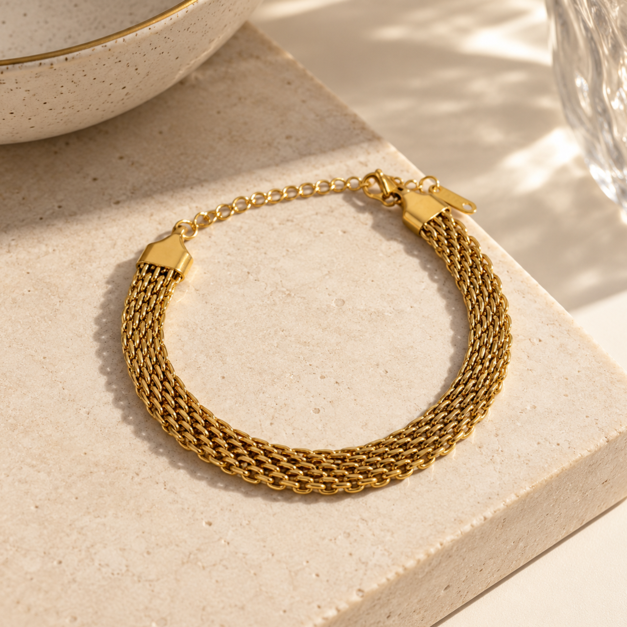 Gold-toned mesh adjustable bracelet from SALVE, featuring a sleek, modern design with a secure clasp.
