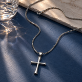 Silver-toned SALVE cross pendant necklace featuring a detailed cross charm on a chain.