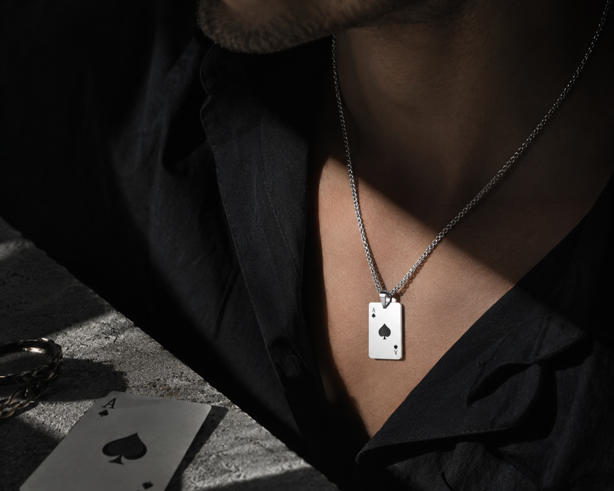 Ikka stainless steel chain pendant necklace for men by SALVE, featuring a sleek, modern design on a black background.