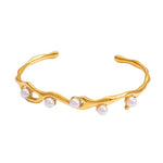 SALVE faux pearl inlaid cuff bracelet featuring a sleek metal design and elegant pearl accents on a neutral background