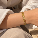 Gold-toned mesh adjustable bracelet by SALVE featuring a sleek, modern design and secure clasp.