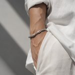 Salve Twin Fish Grey men's bracelet featuring two intertwined fish charms on a sleek cord.