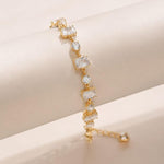 Salve emerald cut and round stone bracelet featuring a stylish design with sparkling green gemstones and silver-tone links.