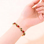 Salve maroon and green tulip bracelet with floral design, featuring intricate metalwork and colorful enamel accents.