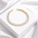 Salve Baguette Stone Tennis Bracelet featuring sparkling rectangular stones and a sleek silver chain design.