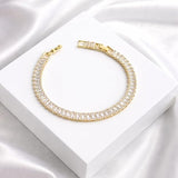 Salve Baguette Stone Tennis Bracelet featuring sparkling rectangular stones and a sleek silver chain design.