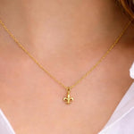 Silver Fleur de Lis pendant necklace by SALVE featuring a detailed decorative charm on a chain.