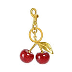 Red glitter cherry keychain from SALVE featuring a sparkling red cherry charm with a silver keyring attachment.