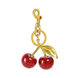 Red glitter cherry keychain from SALVE featuring a sparkling red cherry charm with a silver keyring attachment.