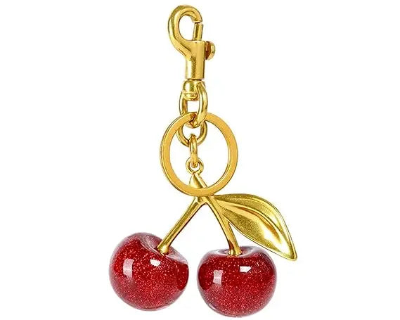 Red glitter cherry keychain from SALVE featuring a sparkling red cherry charm with a silver keyring attachment.