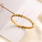 Salve Coquette Floral Daisy Golden Bracelet with delicate floral and daisy charms on a gold-tone chain.