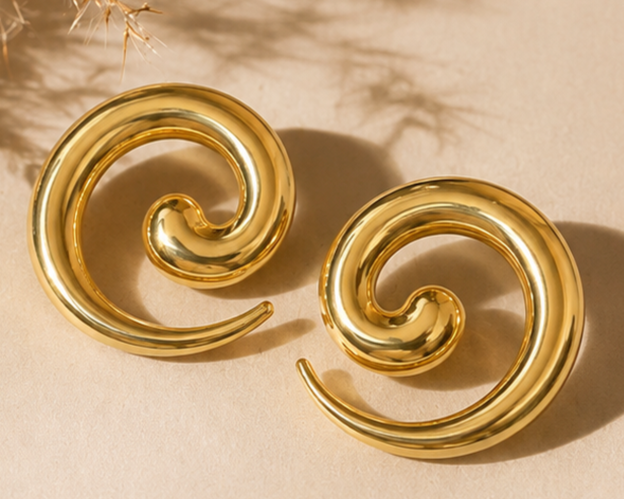 Salve Chic Spiral Statement Earrings featuring large, elegant silver spirals hanging from classic earring hooks.