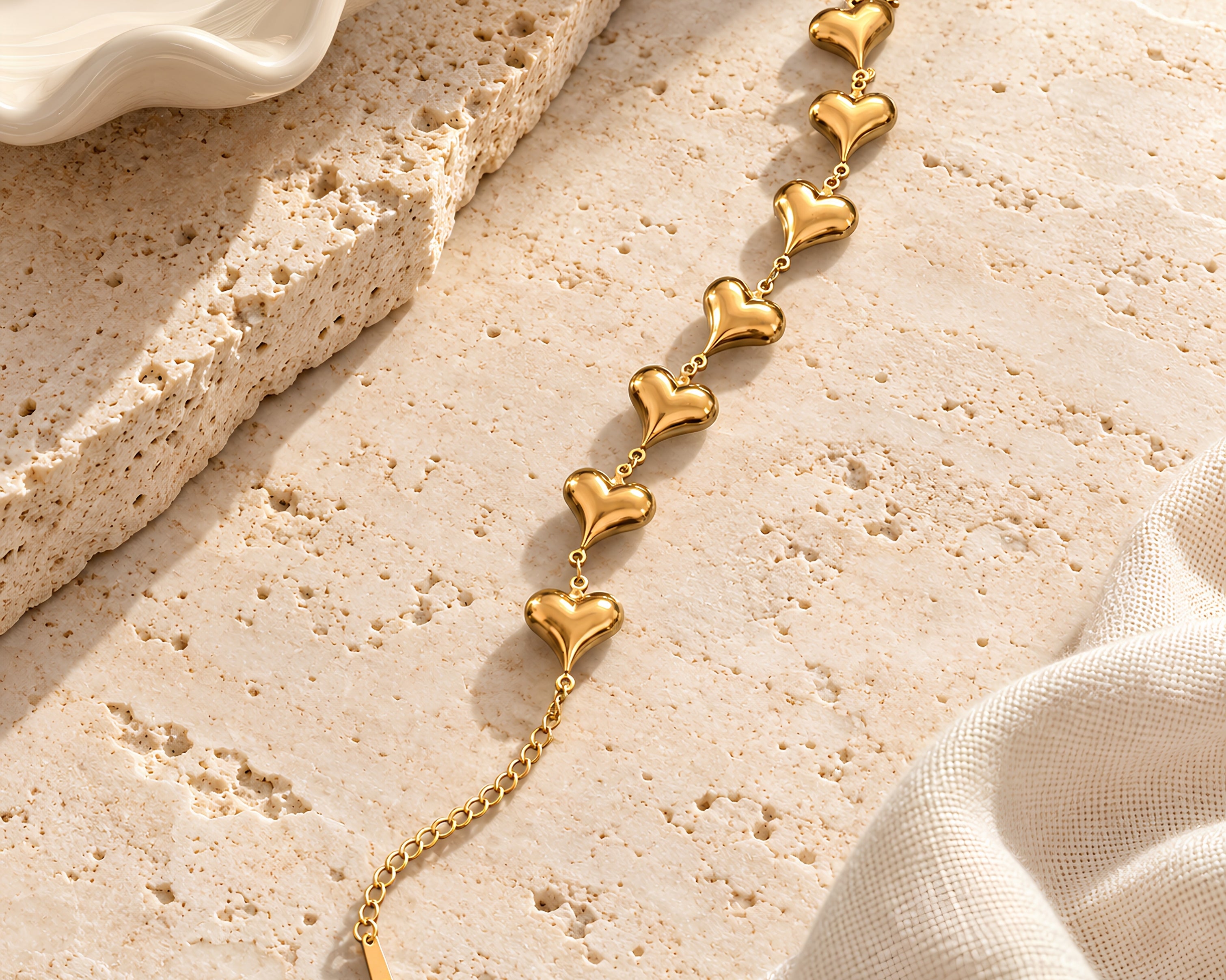 Salve Coquette 7 Hearts gold bracelet with delicate chain and heart-shaped charms, stylish jewelry accessory.