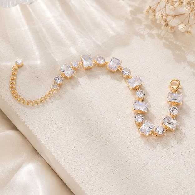 SALVE emerald cut and round stone bracelet featuring shimmering green gemstones and elegant metal links.