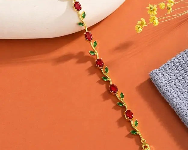Maroon and green tulip-shaped SALVE bracelet with floral design, featuring intricate metalwork and vibrant colors.