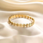 Salve Coquette Floral Daisy Golden Bracelet with delicate flower and leaf design, shiny gold finish, and adjustable chain.