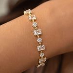Salve emerald cut and round stone bracelet featuring sparkling green gemstones and elegant silver setting.
