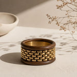 Stack of chunky wooden bangle bracelets from SALVE featuring natural wood textures and smooth, rounded design.
