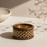 Stack of chunky wooden bangle bracelets from SALVE featuring natural wood textures and smooth, rounded design.