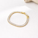 Salve Baguette Stone Tennis Bracelet featuring sparkling rectangular-cut stones on a delicate chain.