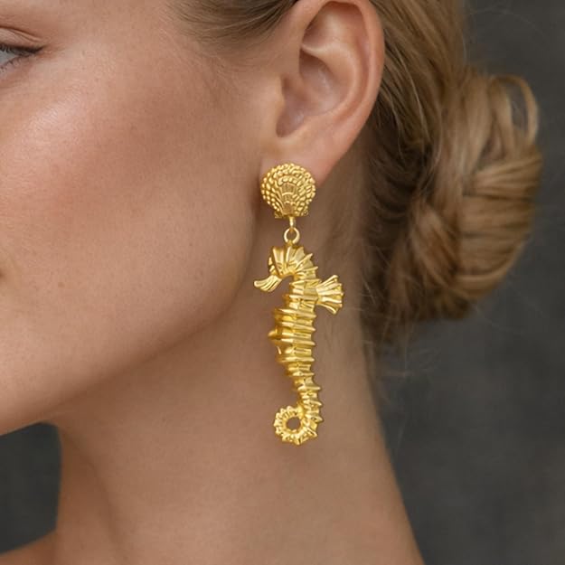 Gold sea horse drop dangle earrings by SALVE featuring intricate sea horse designs and elegant dangling style.