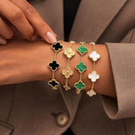 Set of SALVE anti-tarnish clover bracelets with silver-tone finish, featuring four delicate chain bracelets with clover charms.