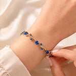 Blue Tulip Bracelet by SALVE featuring a delicate blue tulip charm on a silver chain.