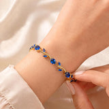 Blue Tulip Bracelet by SALVE featuring a delicate blue tulip charm on a silver chain.
