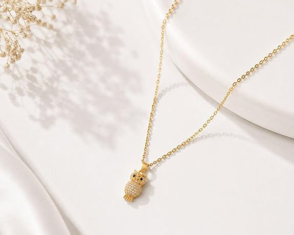 Gold pendant necklace by SALVE featuring a rhinestone owl design, elegant jewelry with intricate detailing.