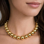 Salve chunky gold beaded aesthetic necklace with large round beads, stylish and modern jewelry accessory.