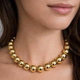 Salve chunky gold beaded aesthetic necklace with large round beads, stylish and modern jewelry accessory.