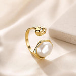 Adjustable SALVE Baroque faux pearl open ring featuring a luminous pearl centerpiece on a sleek metal band.