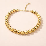 Salve chunky gold beaded aesthetic necklace with large round beads, stylish and trendy jewelry accessory.