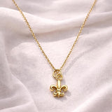 Salve Fleur de Lis pendant necklace featuring a detailed gold-tone pendant hanging from a delicate chain.