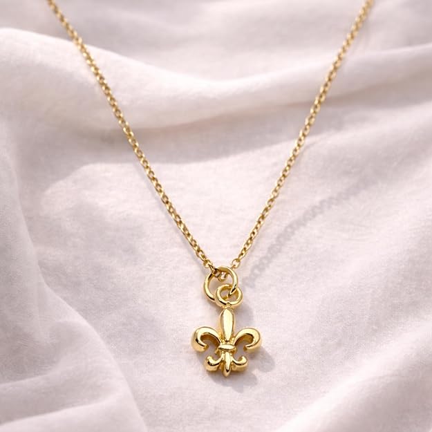Salve Fleur de Lis pendant necklace featuring a detailed gold-tone pendant hanging from a delicate chain.