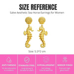 Gold sea horse drop dangle earrings by SALVE featuring intricate sea horse design and hanging dangle style.