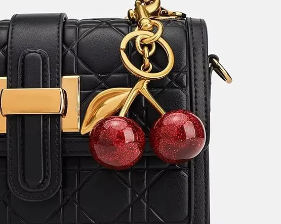 Red glitter cherry keychain from SALVE with sparkling finish and metallic keyring, perfect for accessorizing keys or bags.