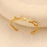 SALVE faux pearl inlaid cuff bracelet showing a sleek metal design with embedded faux pearls for elegant wristwear.