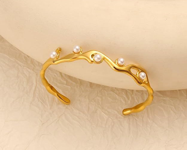 SALVE faux pearl inlaid cuff bracelet showing a sleek metal design with embedded faux pearls for elegant wristwear.
