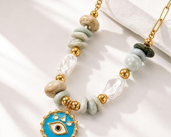 Gold pendant necklace featuring a beachy evil eye design from SALVE, stylish jewelry for boho or casual look.