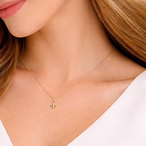 Salve Fleur de Lis pendant necklace featuring a detailed gold-toned charm on a delicate chain, close-up view of the jewelry.