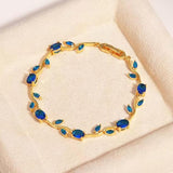 Blue tulip-shaped bracelet by SALVE featuring detailed floral design and vibrant blue color on a neutral background.