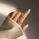 SALVE CZ studded cross ring featuring metallic band with embedded sparkling CZ stones, stylish jewelry accessory.