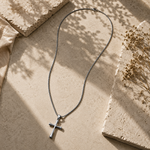 Silver-toned SALVE cross pendant necklace featuring a detailed Christian cross design on a sleek chain.